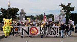 Crowds cross Arlington Memorial Bridge as part of a No Kings protest, Saturday, Oct. 18, 2025, in Washington, D.C. Photo credit: Allison Robbert, The Associated Press