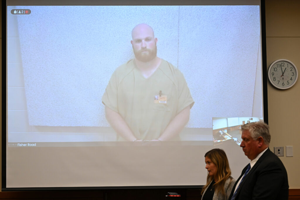 Blendon Township, Ohio, police officer Connor Grubb listens while appearing via video from jail for his arraignment hearing on Aug. 14, 2024, at the Franklin County Court of Common Pleas in Columbus. Photo credit: David Dermer, The Associated Press